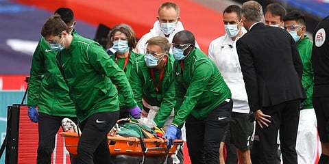 Manchester United's Eric Bailly is taken from the field after a clash of heads during the English FA Cup semifinal against Chelsea. (Photo | AP)