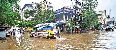 An ambulance plies on a waterlogged street after heavy rainfall in Patna | PTI