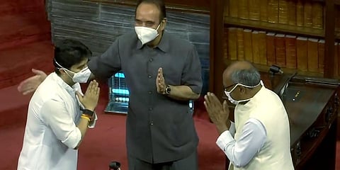 BJP leader Jyotiraditya Scindia greets Congress leaders Ghulam Nabi Azad and Digvijaya Singh before taking oath as Rajya Sabha MP, in New Delhi. (Photo| ANI)