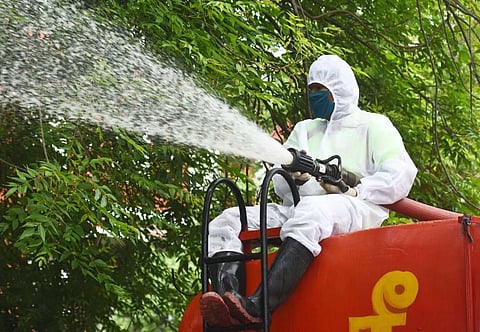 Fire department personnel spray disinfectant in Wallaja Salai area of Chennai. (Photo | Ashwin Prasath, EPS)