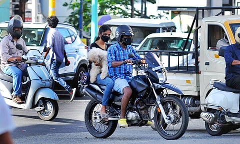 Two youngesters carrying their pet dog without maintaining social distancing norms. Even while Covid cases are on the rise in Kochi, people seem to be callous. (Photo | A Sanesh, EPS)