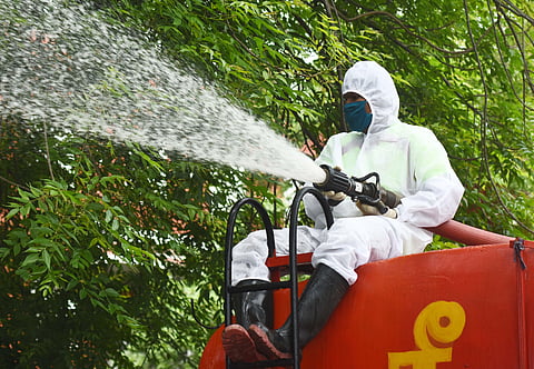 Fire department officials spray disinfectants. (Photo | Ashwin Prasath, EPS)