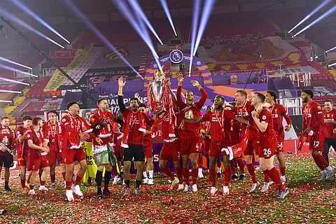 Liverpool players celebrate with the English Premier League trophy following the English Premier League soccer match between Liverpool and Chelsea at Anfield Stadium in Liverpool, England. (Photo |AP)