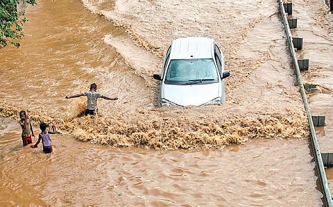 A car moves through waterlogged Delhi-Gurugram Expressway