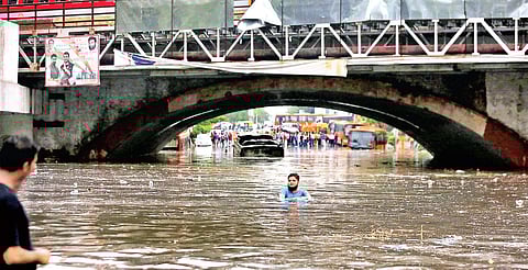 Buses were submerged on an inundated road under Minto Bridge in New Delhi after a heavy spell of showers. (Photo | Shekhar Yadav, EPS)