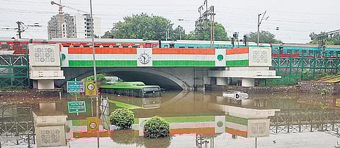 A DTC bus and a good carrier can been seem submerged under the Minto Road Railway Bridge after heavy rains. (Photo | EPS)