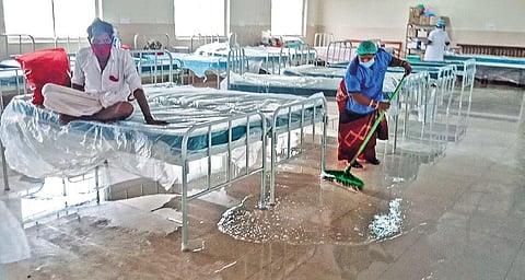 A sanitation worker cleans a flooded ward on the fourth floor of the Quli Qutb Shah at OGH on Thursday (Photo | Vinay Madapu, EPS)