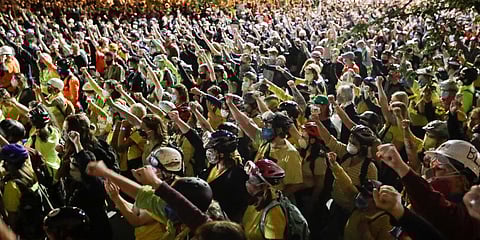 Demonstrators raise their fists during a Black Lives Matter protest at the Mark O Hatfield United States Courthouse. (Photo| AP)