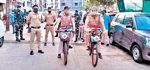 Delhi Police inspector Bala Shankar Upadhyay and his team bicycled through the narrow lanes of containment zones in Delhi to calm people's fears.