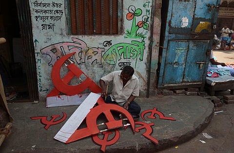 File: A man paints the CPM symbol to used for a rally. (Photo| AFP)