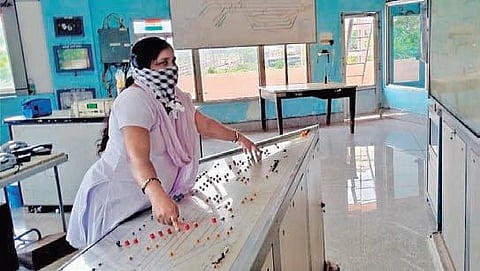 A woman railway employee regulates train services at Vizag station I Express