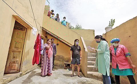 School teachers conduct a door-to-door survey to detect Covid-19 cases at Mahipalpur in New Delhi
