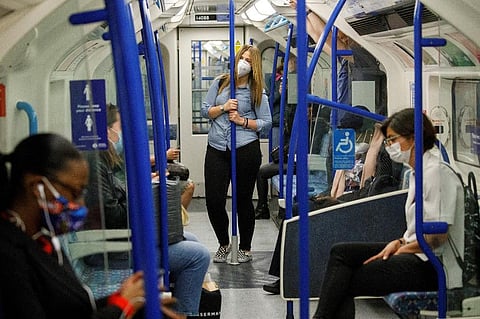 Commuters wearing a face mask travel on TfL Victoria Line underground train carriages, heading towards central London, on June 15, 2020. (Photo | AFP)