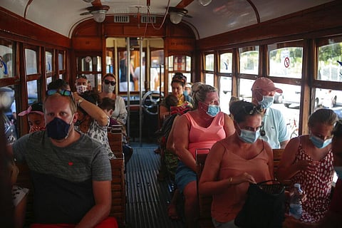 Tourists and locals ride a tram in town of Sóller in the Balearic Island of Mallorca, Spain, Monday, July 27, 2020. (Photo | AP)
