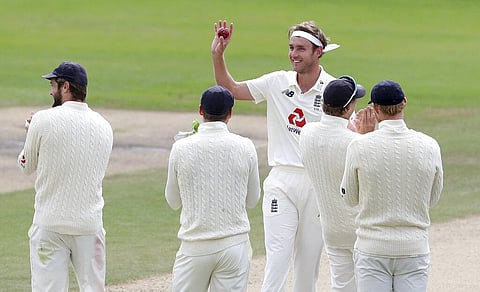 England's Stuart Broad, center, holds the ball to celebrate taking 500 wickets during the fifth day of the third cricket Test match between England and West Indies. (Photo | AP)