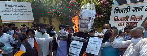 BJP workers burn effigy of Delhi CM Arvind Kejriwal bills during a protest against AAP government over electricity bills in New Delhi on Monday. (Photo| Shekhar Yadav, EPS)