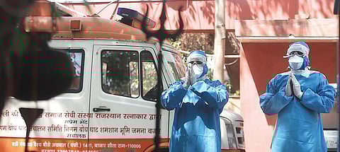 HCWs in protetive gear offer puja at a temple at Nigambodh Ghat. (File photo| EPS)