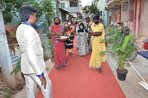 Ramchandra Rao, in a suit, is all set to welcome back his wife Kalavathy at their house in Tumakuru