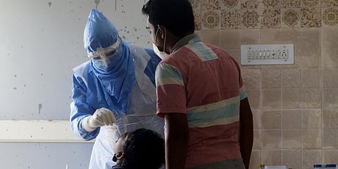 A health worker collecting swab sample near Ganganagar in Bhubaneswar. (Photo| EPS)