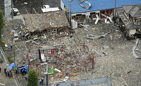 Investigators work near a damaged building following an explosion in Japan's Koriyama(Photo| AP)
