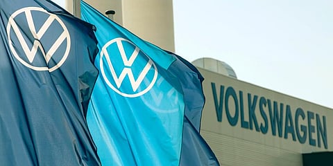 Flags wave in front of a factory building during the production restart of the plant of the German manufacturer Volkswagen. (Photo | AP)
