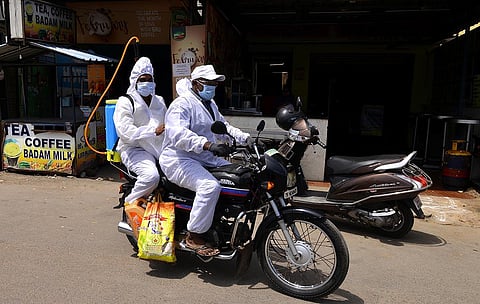 Sanitation workers leaving after spraying disinfectant at Arumbakkam in Chennai. (Photo | Debadatta Mallick, EPS)