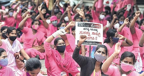 ASHA workers had been protesting since July 10, demanding a fixed monthly honorarium of Rs 12,000 and an adequate supply of PPE kits | EXPRESS