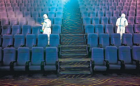 Snapshots of INOX staff demonstrating their sanitisation process at their movie halls