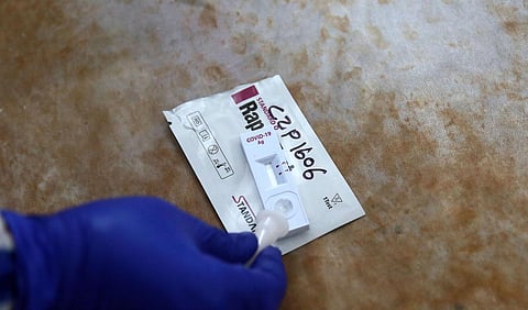 A medical lab technician collects swab sample. (Photo | Shekhar Yadav, EPS)