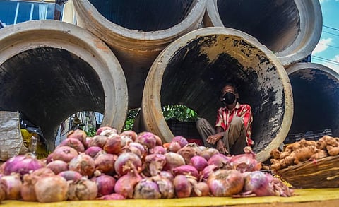 A vegetable vendor takes shelter in a concrete pipe near Jharpada during lockdown in Bhubaneswar. (Photo | Biswanath Swain, EPS)