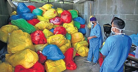 Staff members dispose of PPE kit waste in LNJP Hospital. (Photo | Shekhar Yadav, EPS)