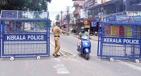 A policeman stopping and asking a two-wheeler rider to go back as he comes from a containment zone in Thiruvananthapuram. (Photo | Vincent Pulickal, EPS)