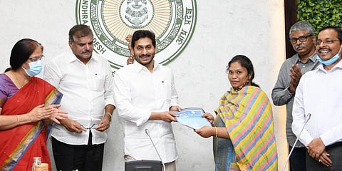 Andhra Pradesh CM YS Jagan Mohan Reddy handing over the appointment letters to the outsourcing employees after launching the APCOS in Tadepalli on Friday. (Photo| EPS)