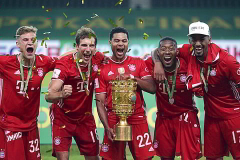 Bayern Munich players celebrate with the trophy after winning the German soccer cup (DFB Pokal) final match between Bayer 04 Leverkusen and FC Bayern Munich in Berlin, Germany. (Photo | AP)