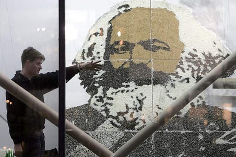 'Nothing can have value without being an object of utility.' IN PIC: An artist completes an installation featuring a giant portrait of German philosopher and historian Karl Marx, in a Berlin gallery 03 February 2005. (Photo | AFP)
