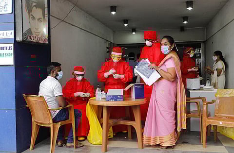 Sri Lankan municipal health workers take a blood sample from a man during screening for COVID- 19 antibodies at a market place in Colombo, Sri Lanka, Friday, June 26, 2020. (Photo | AP)