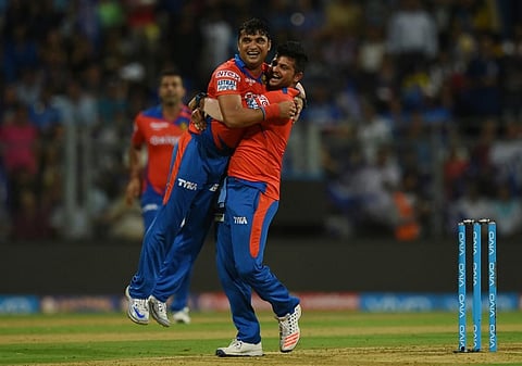 Suresh Raina (R) lifts Pravin Tambe. (Photo | AFP)