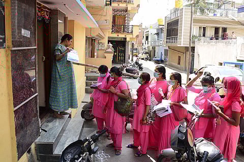 Asha workers take details from members of a house to curb the spread of coronavirus in Bengaluru. (Photo | Vinod Kumar T, EPS)
