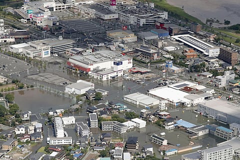 Streets are flooded following a heavy rain in Kurume, Fukuoka prefecture, southern Japan. (Photo | AP)