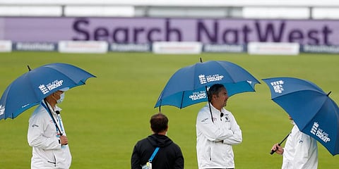 Umpires hold umbrellas as rain delayed start of the first day of the 1st cricket Test match between England and West Indies, at the Ageas Bowl in Southampton. (Photo | AP)