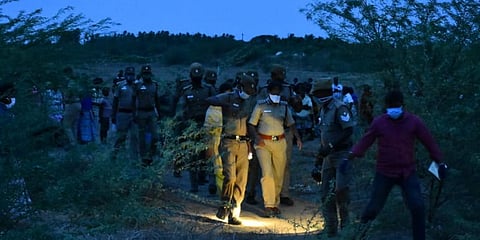 Police officials investigate the crime scene where the body of a 14-year-old girl was found charred to death near Adhavathur in Tiruchy on Monday. (Photo| EPS)