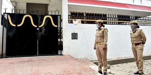Police personnel stand guard outside the residence of gangster Vikas Dubey at Krishna Nagar in Lucknow on Thursday. (Photo| ANI)