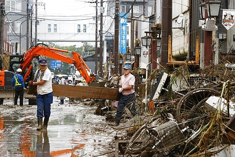 People work for recovery efforts as the city was affected by a heavy rain in Hitoyoshi, Kumamoto prefecture, southern Japan Thursday, July 9, 2020. Pounding rain spread to central Japan and triggered mudslides. (Photo | AP)