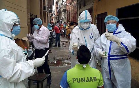Health workers collect swab samples for COVID-19 testing at a containment zone in Patiala Wednesday July 8 2020. (Photo | PTI)
