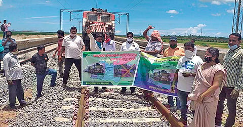 Locals staging rail roko infront of the goods train at Nuagaon on Friday | Express