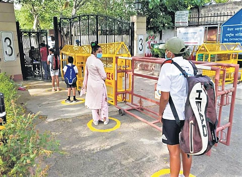 Players wearing masks enter Major Dhyan Chand Stadium after sports complexes were allowed to reopen. (Photo | EPS)