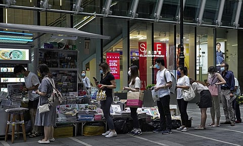People queue up at a news stand to buy copies of Apple Daily in Hong Kong Tuesday, Aug. 11, 2020, as a show of support, a day after the arrest of its founder Jimmy Lai (Photo | AP)