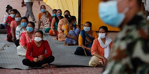 Nepalese people who have travelled outside the Kathmandu valley wait to give swab samples for COVID-19 test in Kathmandu. (Photo | AP)