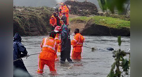 Rescue workers pull out bodies of the Rajamala landslide victims from the Pettimudi stream. (Photo | Express)