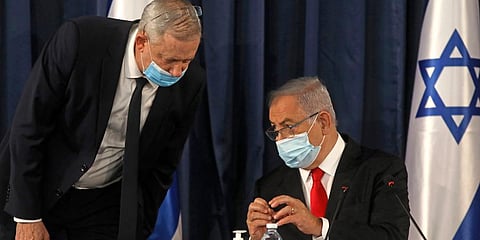 Israeli Prime Minister Benjamin Netanyahu (R) interacting with Defense Minister Benny Gantz. (Photo | AP)
